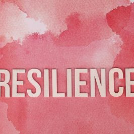 the word resilience on pink surface
